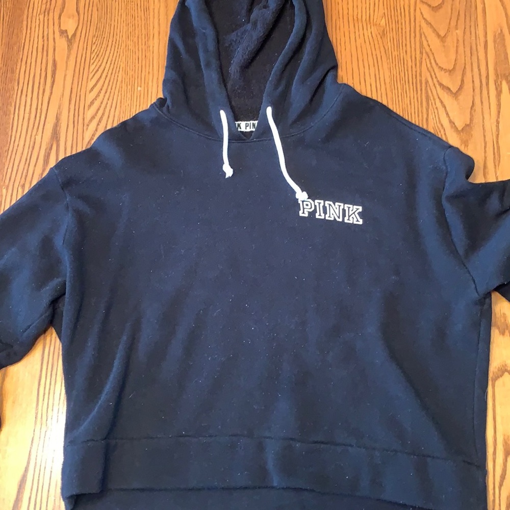 Pink cropped black hoodie.